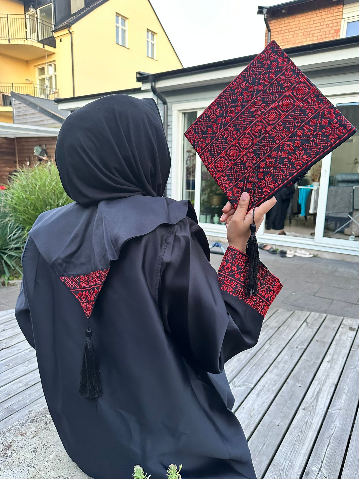 Graduation robe, scraf anad hat with the traditional Palestinan embroidery