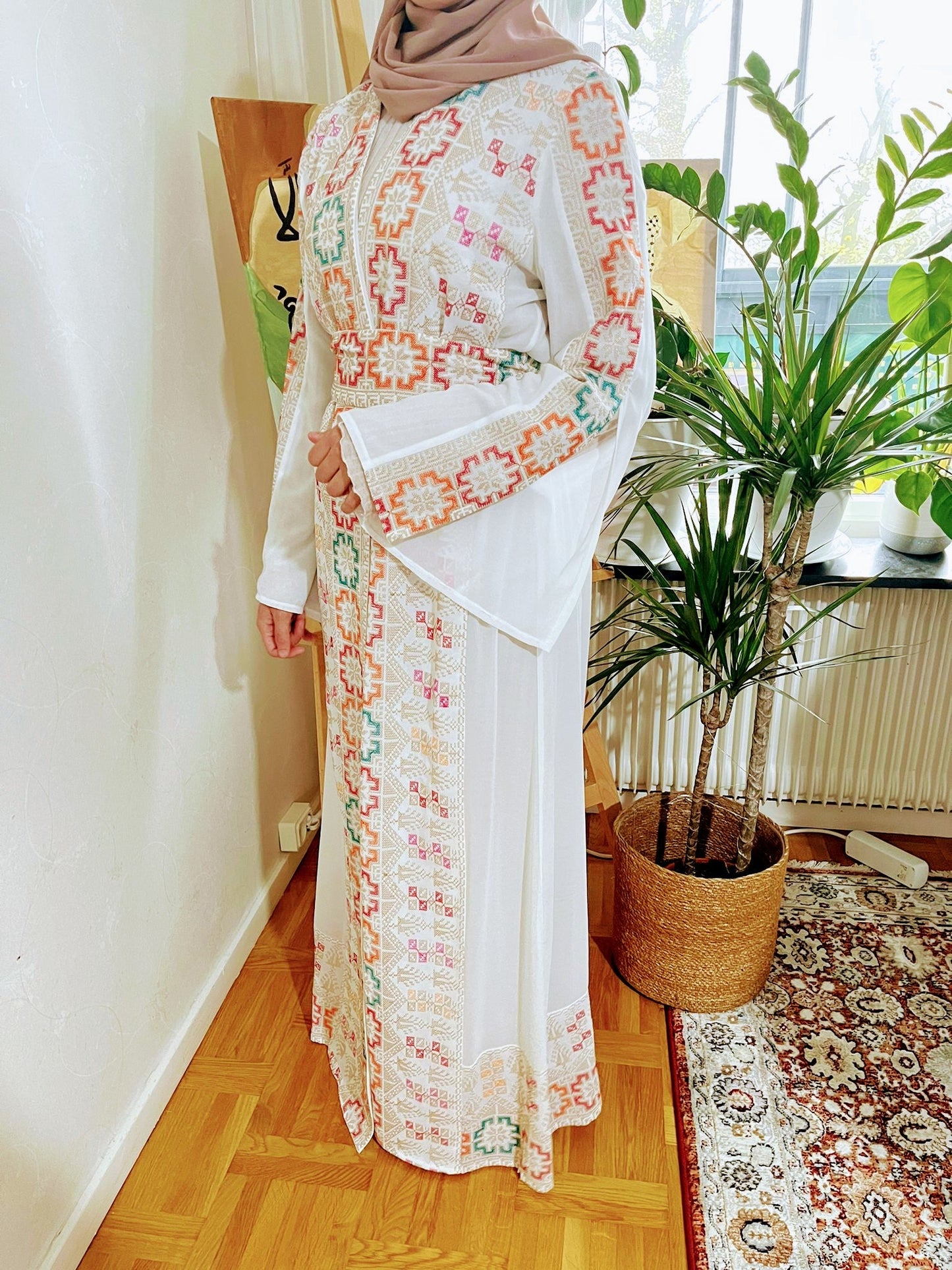 White Abaya with colorful traditional embroidery.