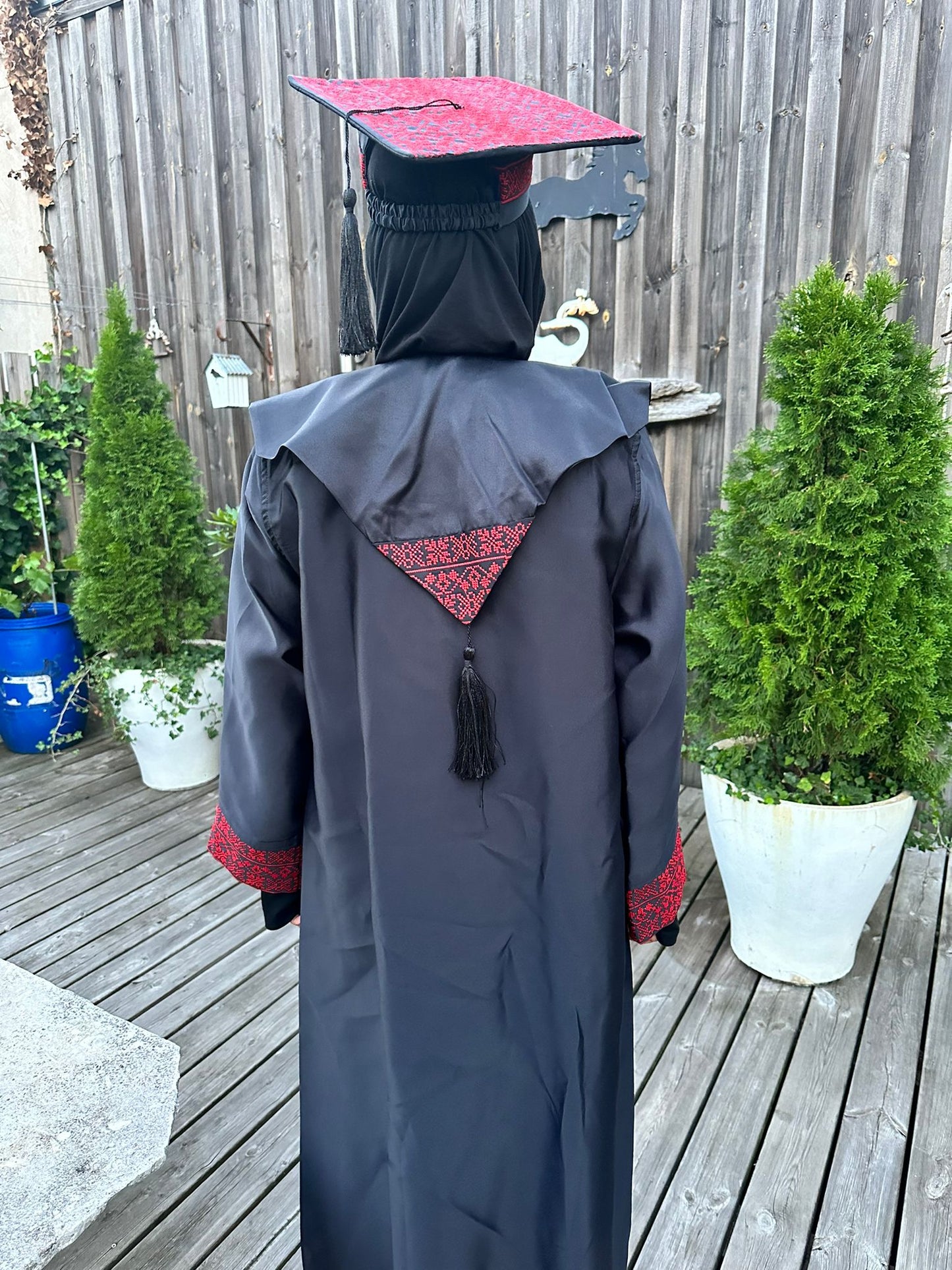 Graduation robe, scraf anad hat with the traditional Palestinan embroidery