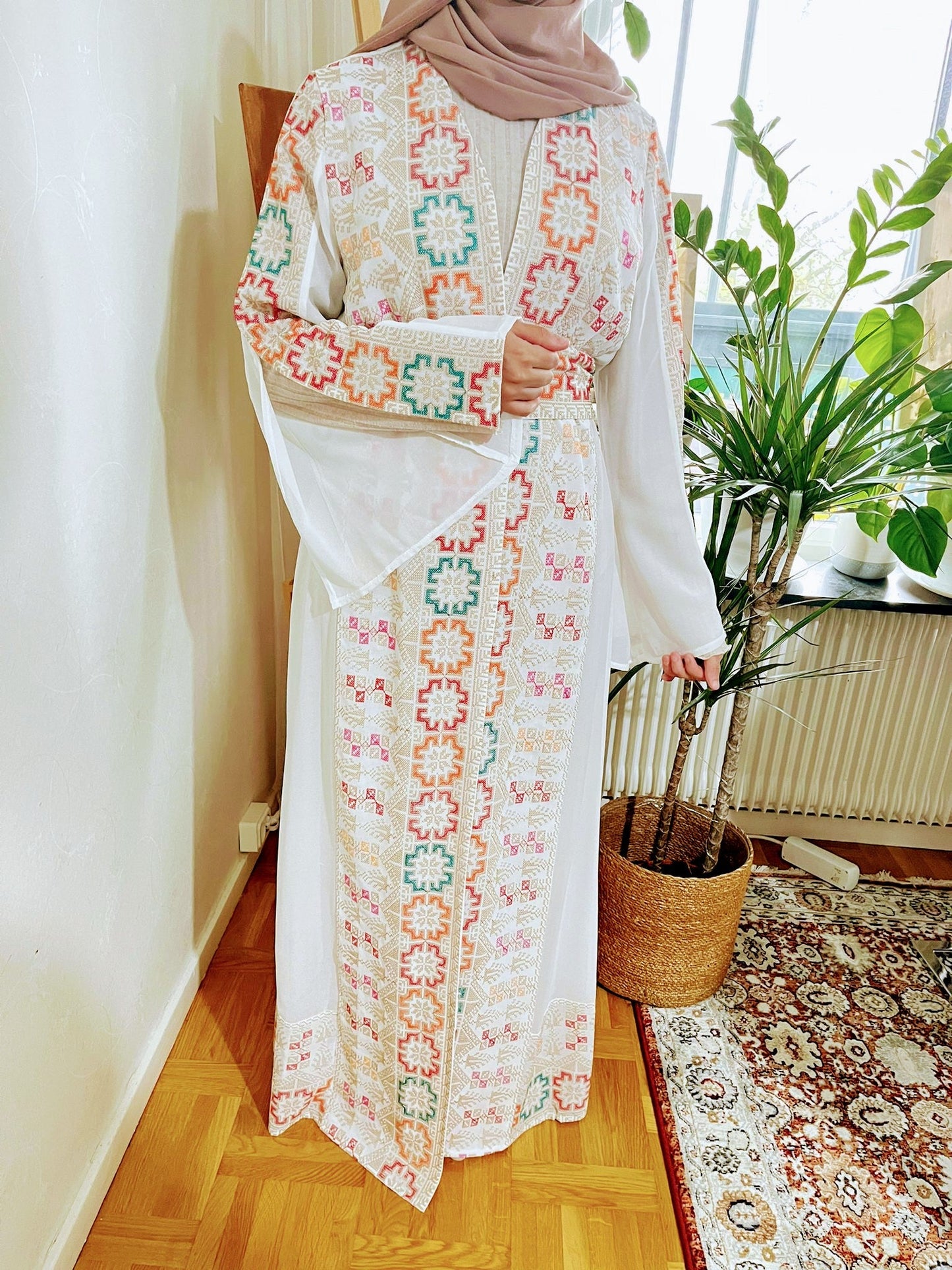 White Abaya with colorful traditional embroidery.