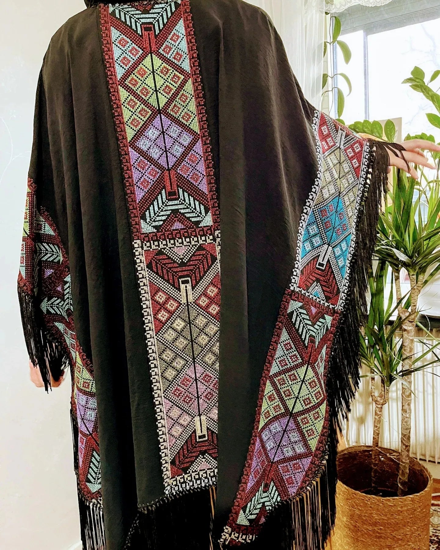 Cape with colorful traditional embroidery .